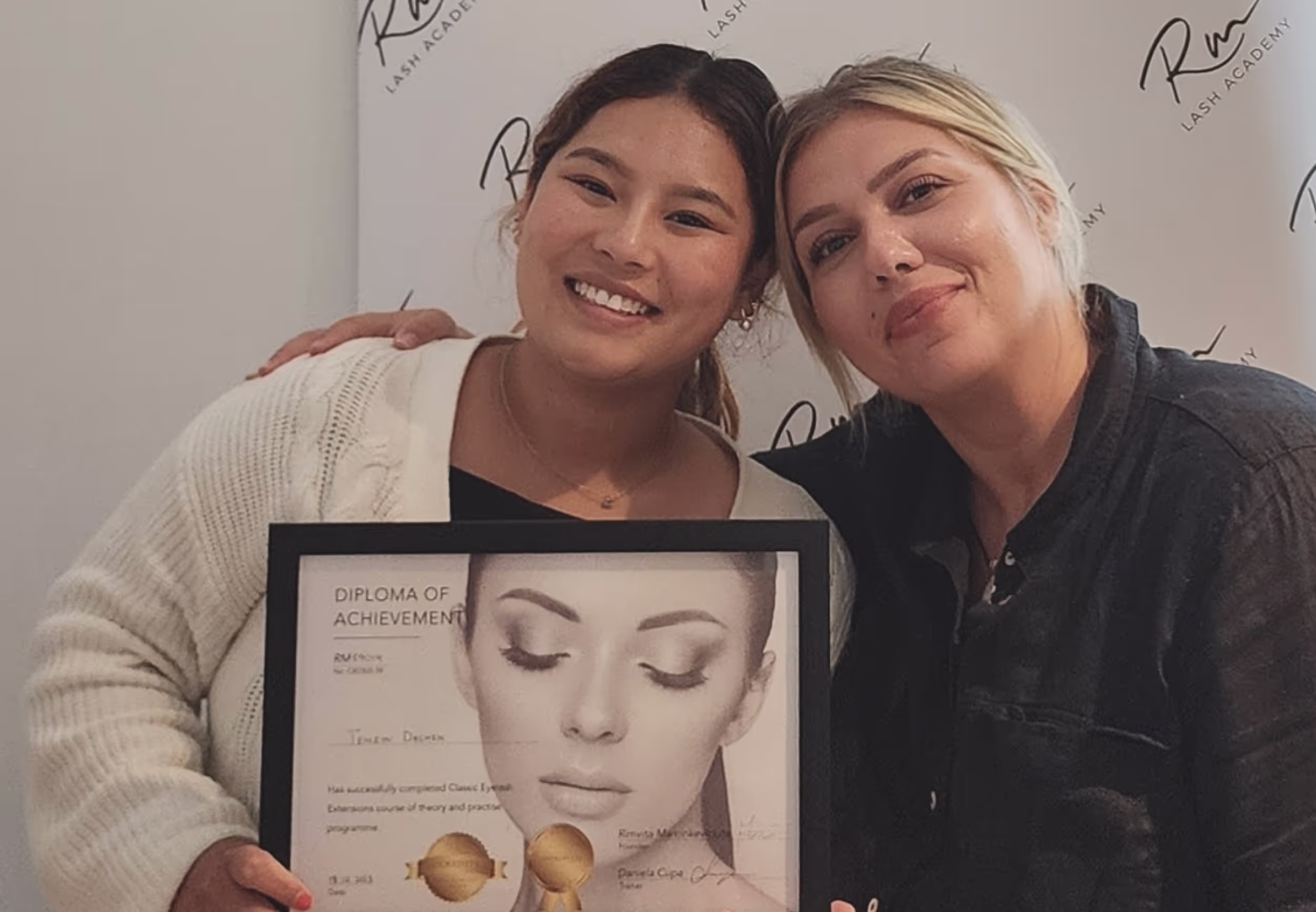 Lash student and trainer holding a certificate