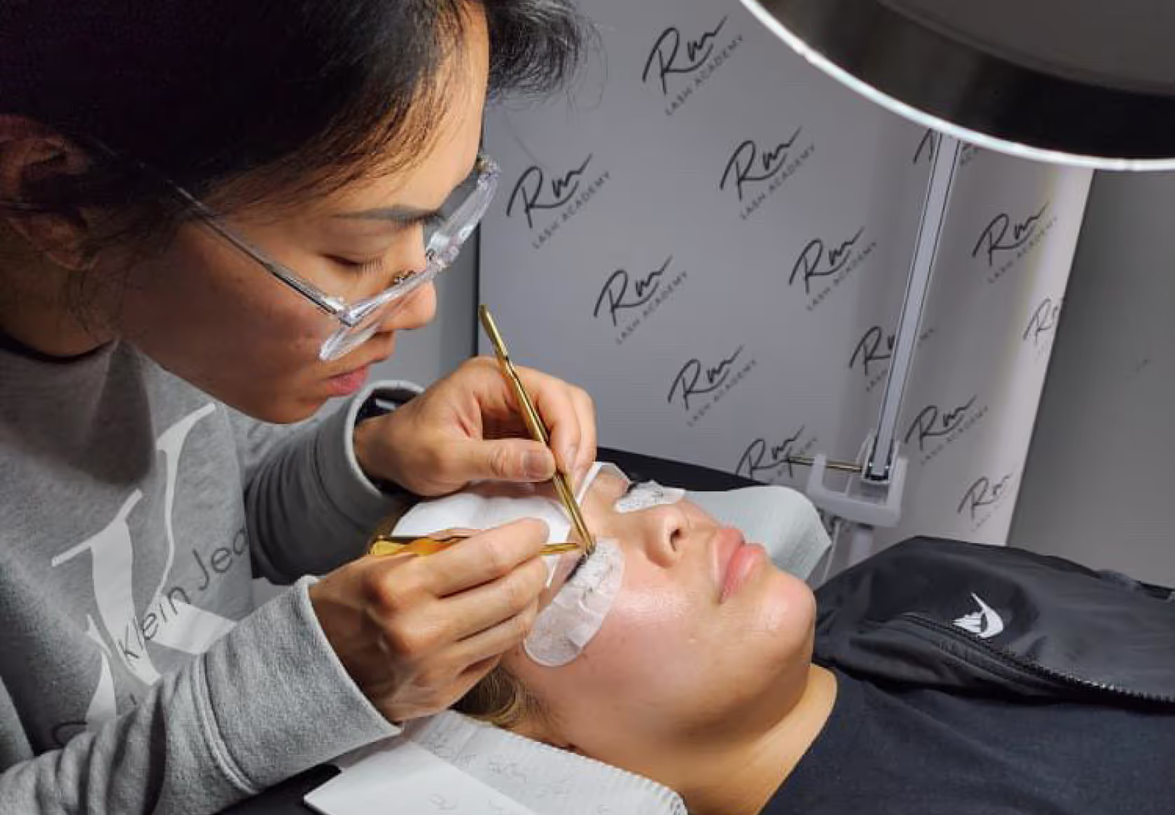 Applying lash extensions on a model.